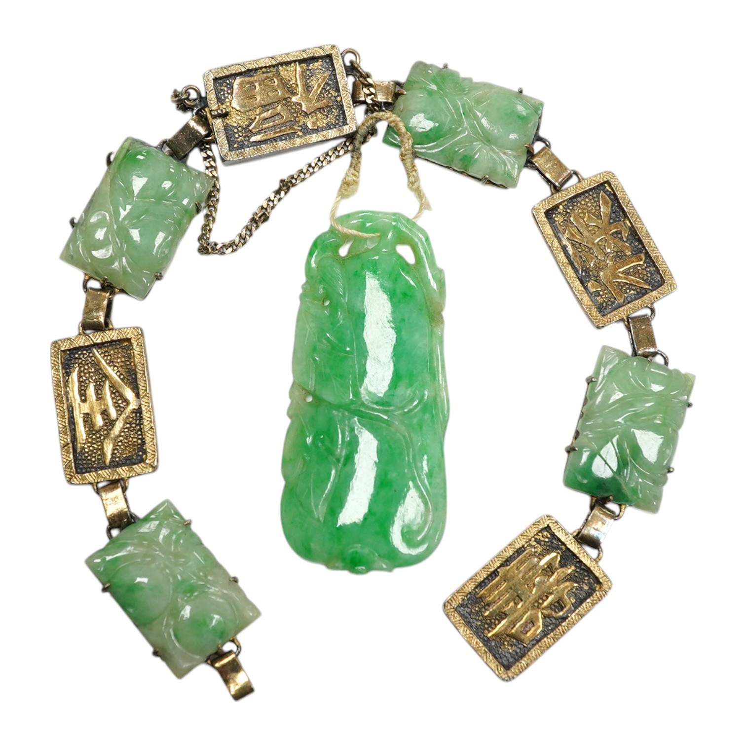 A Chinese gilt white metal and carved jade panel set bracelet, a.f, 17.5cm, together with a carved jade pendant, 40mm. Condition - poor to fair